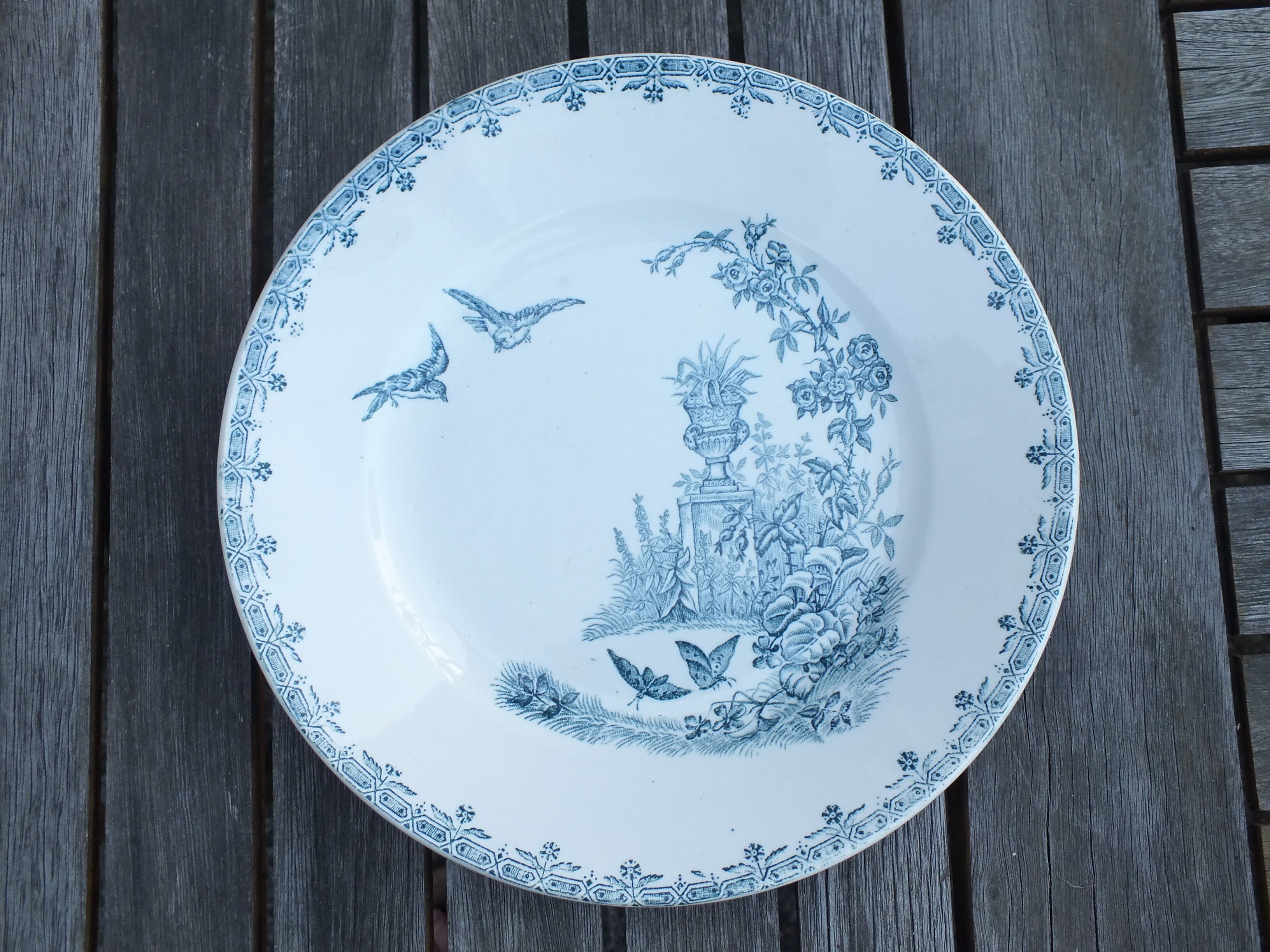 Duo of old plates in Iron Earth decorated with birds and butterflies