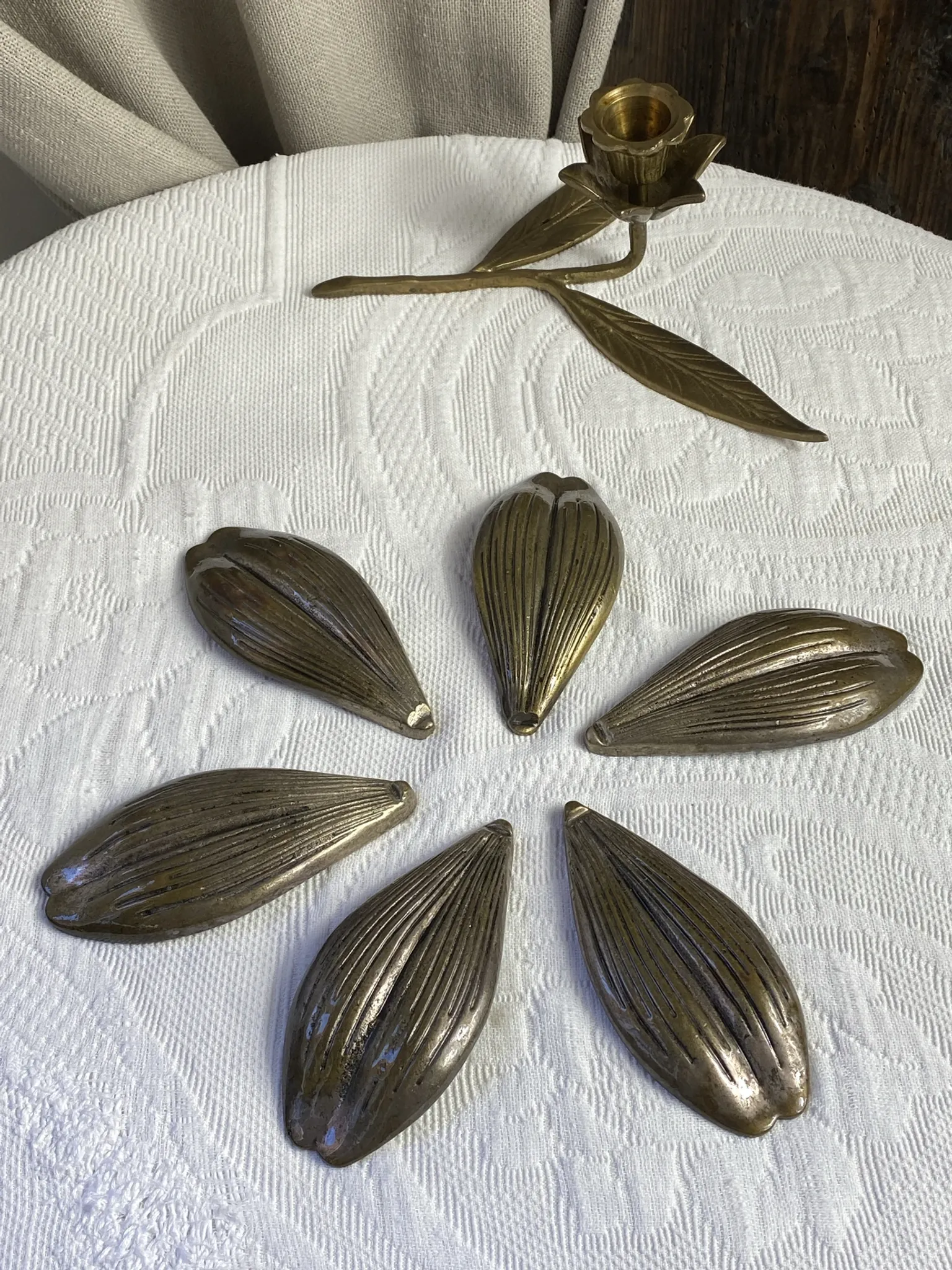 Flower candlestick and removable ashtrays in solid brass.