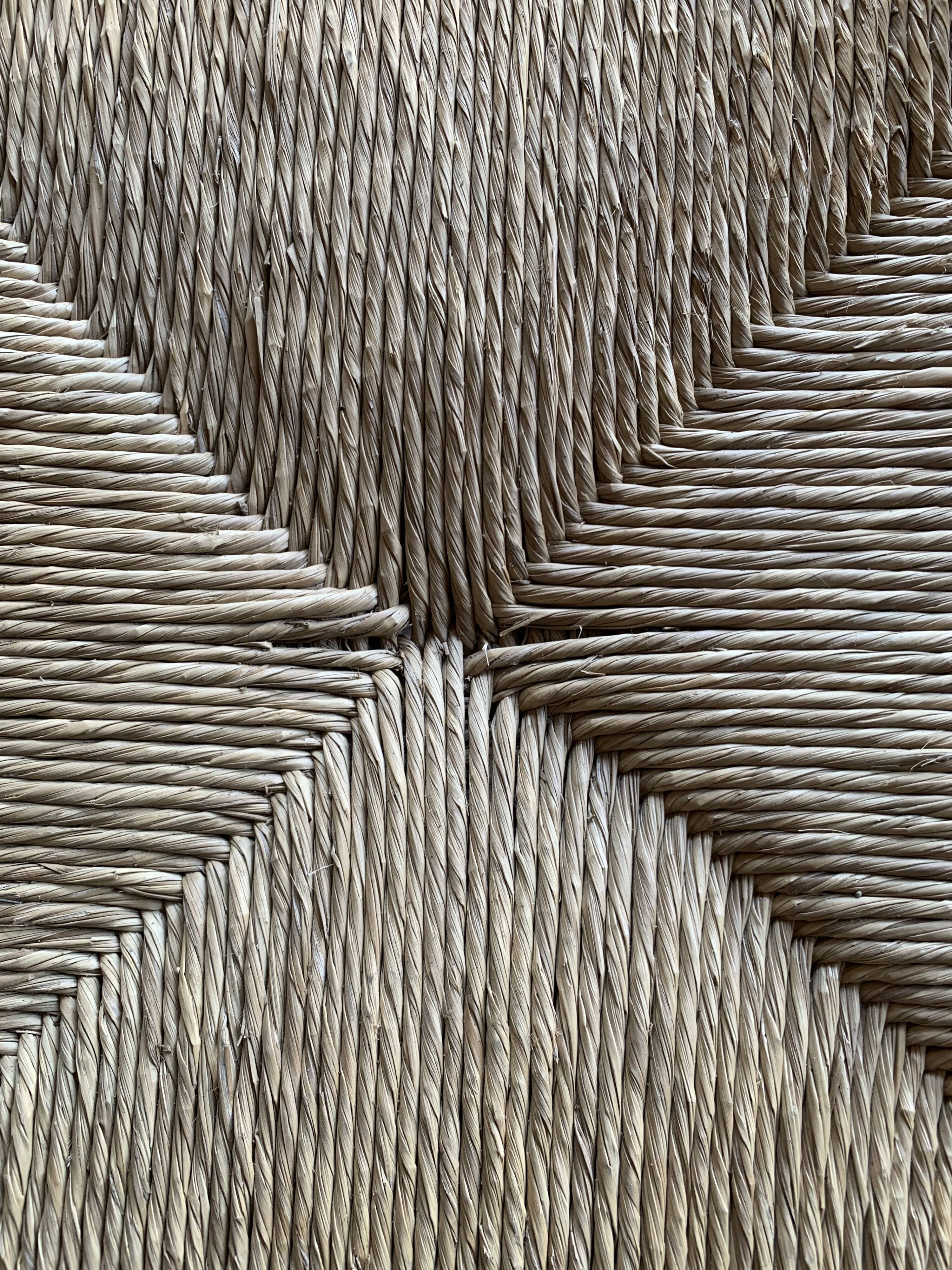 Set of 4 solid wood chairs with straw seats.