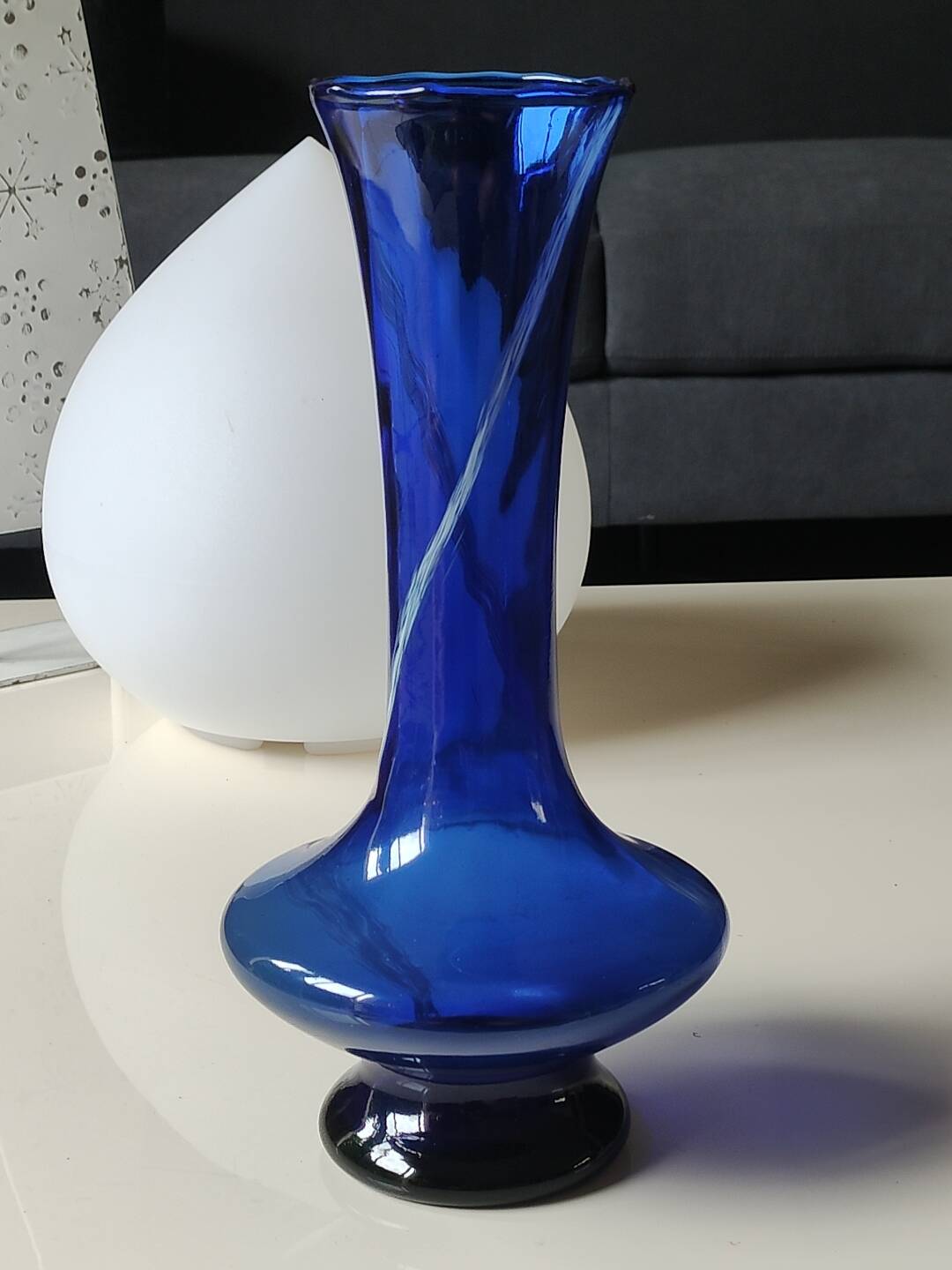 Long flared neck ball vase. Smoked scrolls in cobalt blue art glass, 30cm