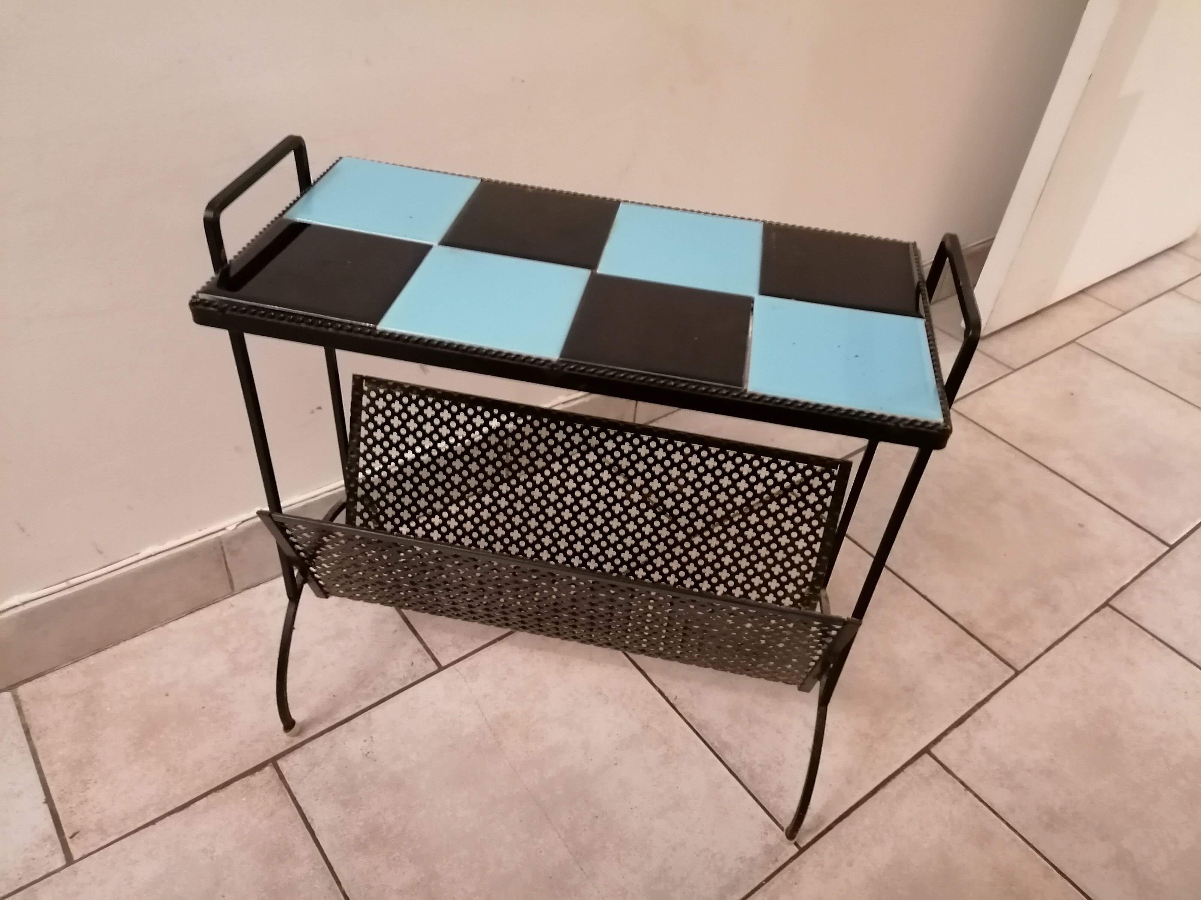 Table carries steel magazines perforated sheet metal vintage ceramic checkerboard