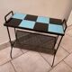 Table carries steel magazines perforated sheet metal vintage ceramic checkerboard