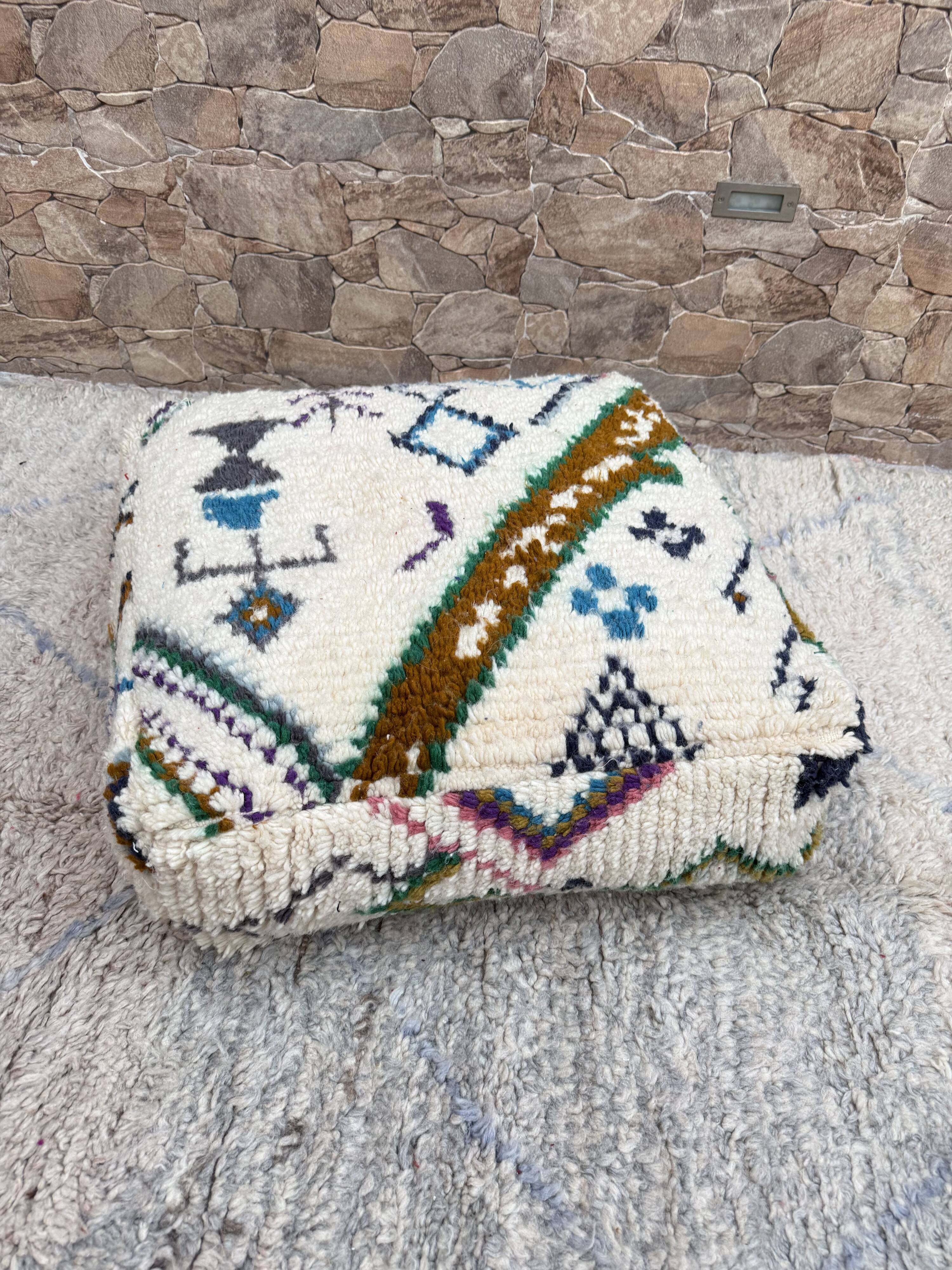 Berber floor pouf: Handwoven Moroccan wool cushion.