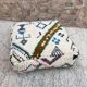 Berber floor pouf: Handwoven Moroccan wool cushion.