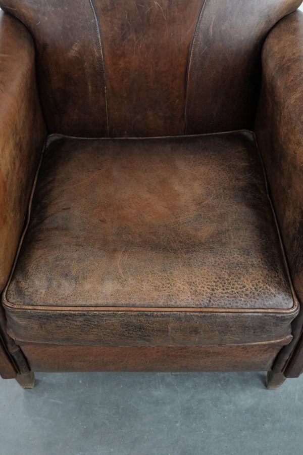 Beautiful vintage sheep leather armchair with a characterful appearance