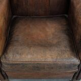 Beautiful vintage sheep leather armchair with a characterful appearance