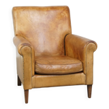 Stylish patinated vintage sheepskin armchair with a comfortable seat