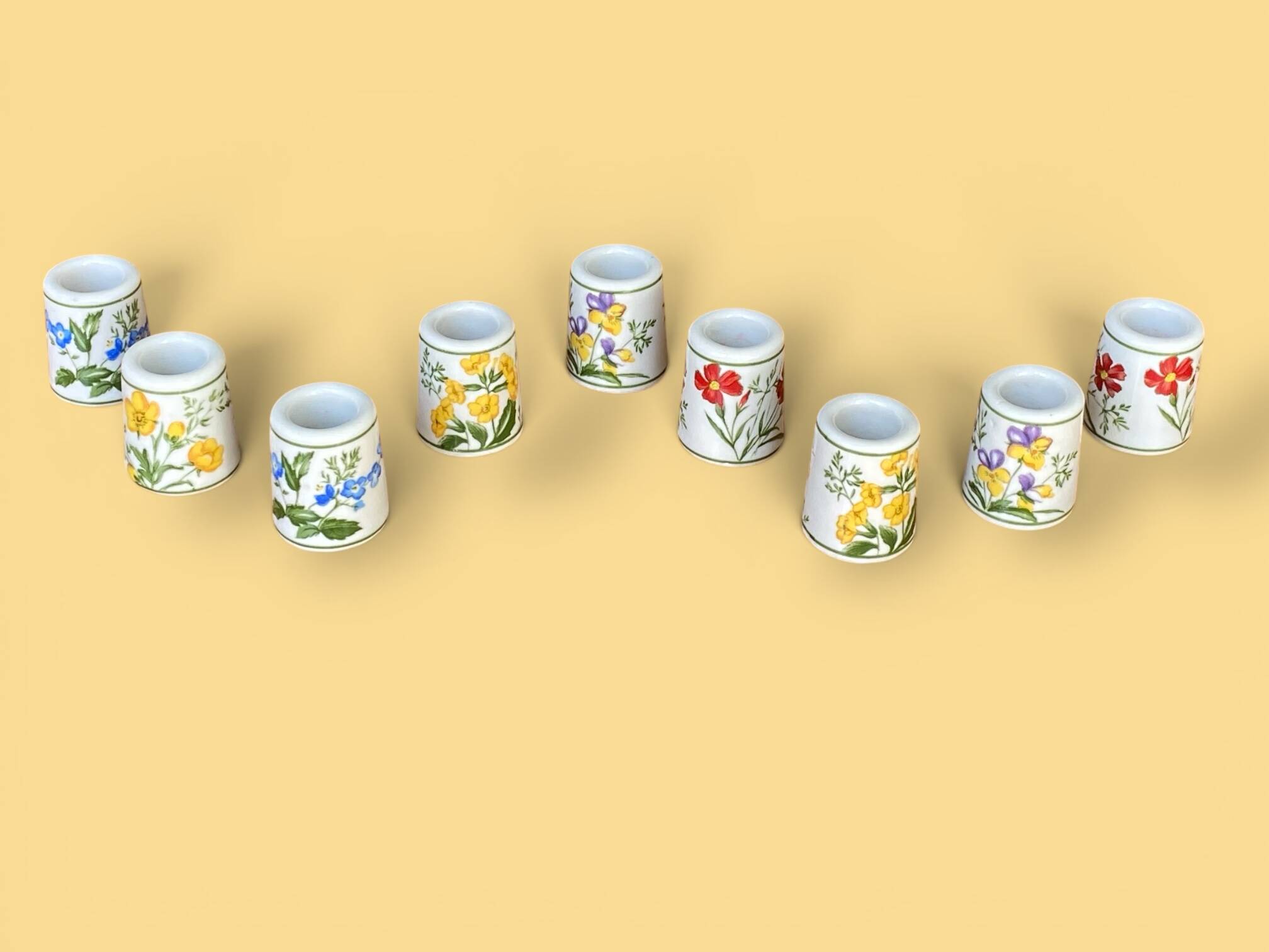 Set of 9 mini vintage porcelain candle holders decorated with spring flowers.