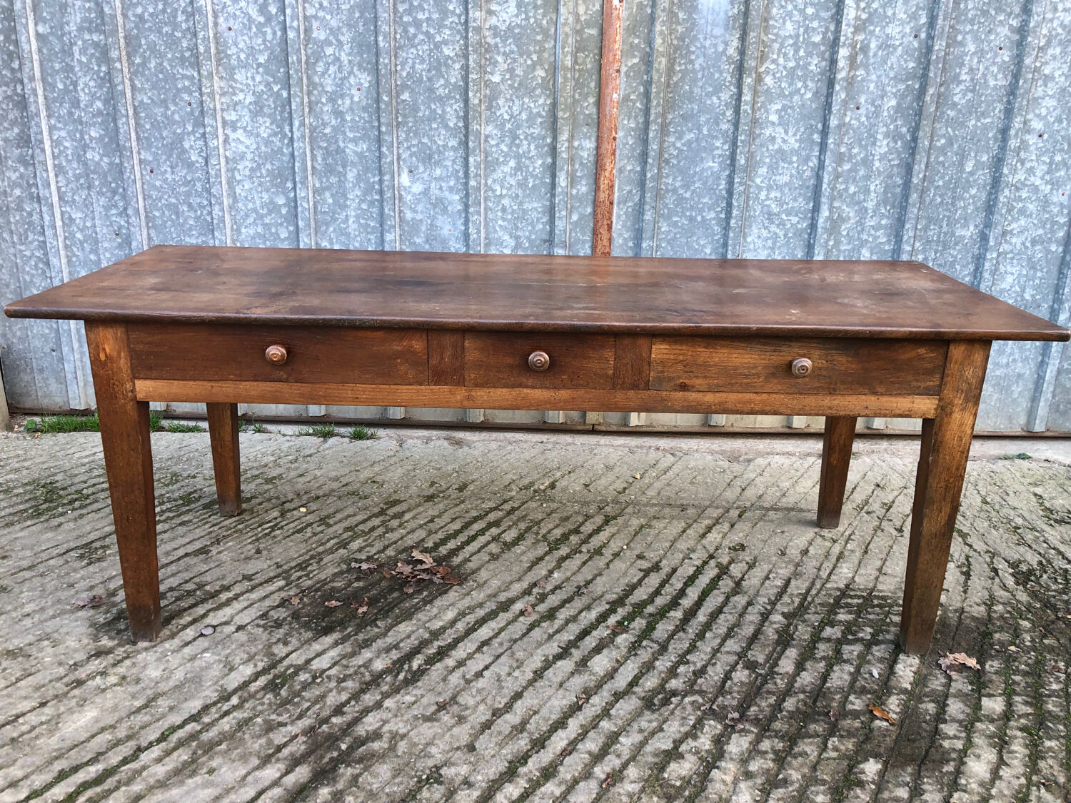 Antique chestnut farmhouse table with 3 drawers on the front.