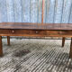 Antique chestnut farmhouse table with 3 drawers on the front.