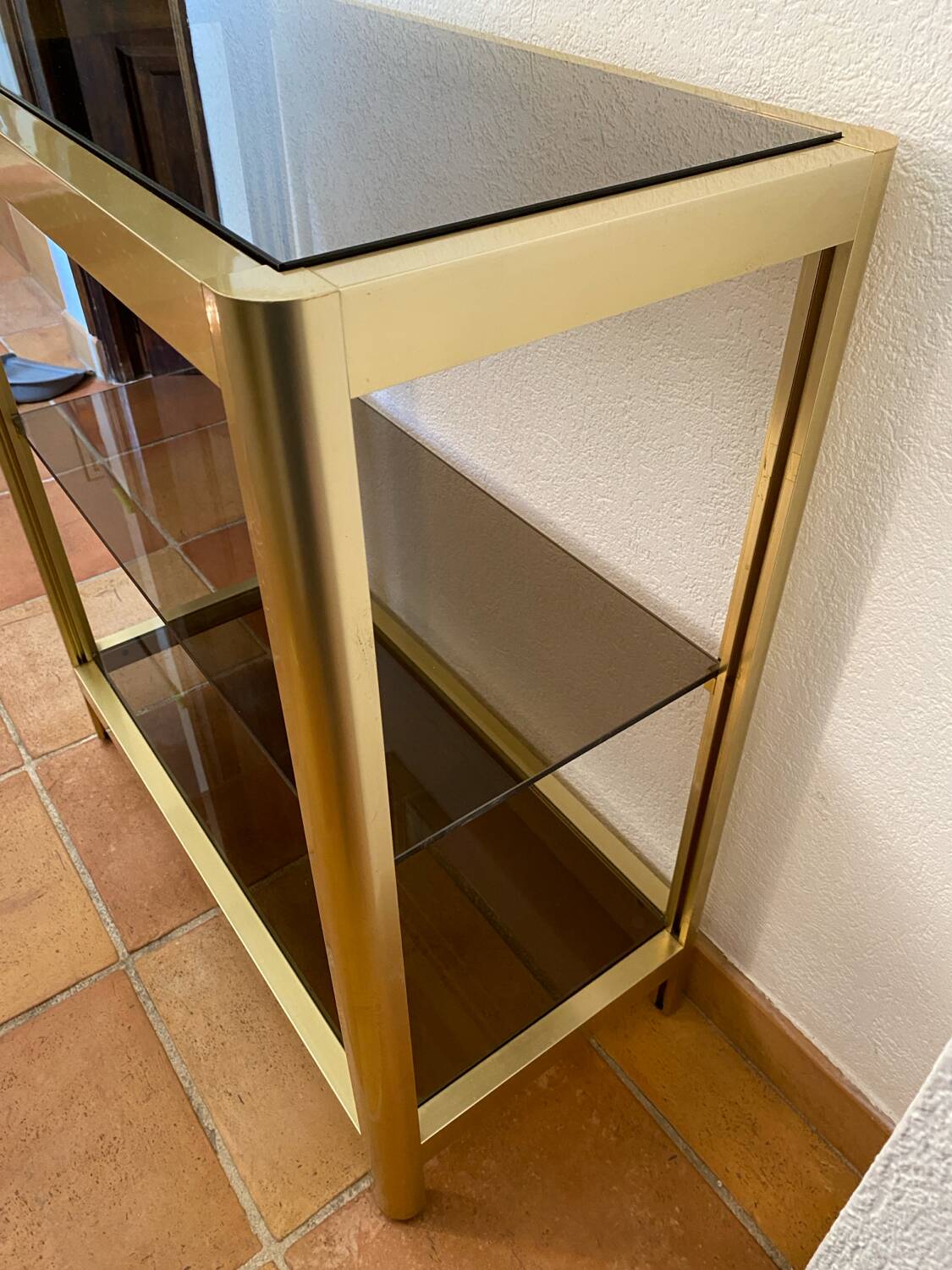 Regency style console table, in gilded metal and smoked glass