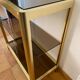 Regency style console table, in gilded metal and smoked glass