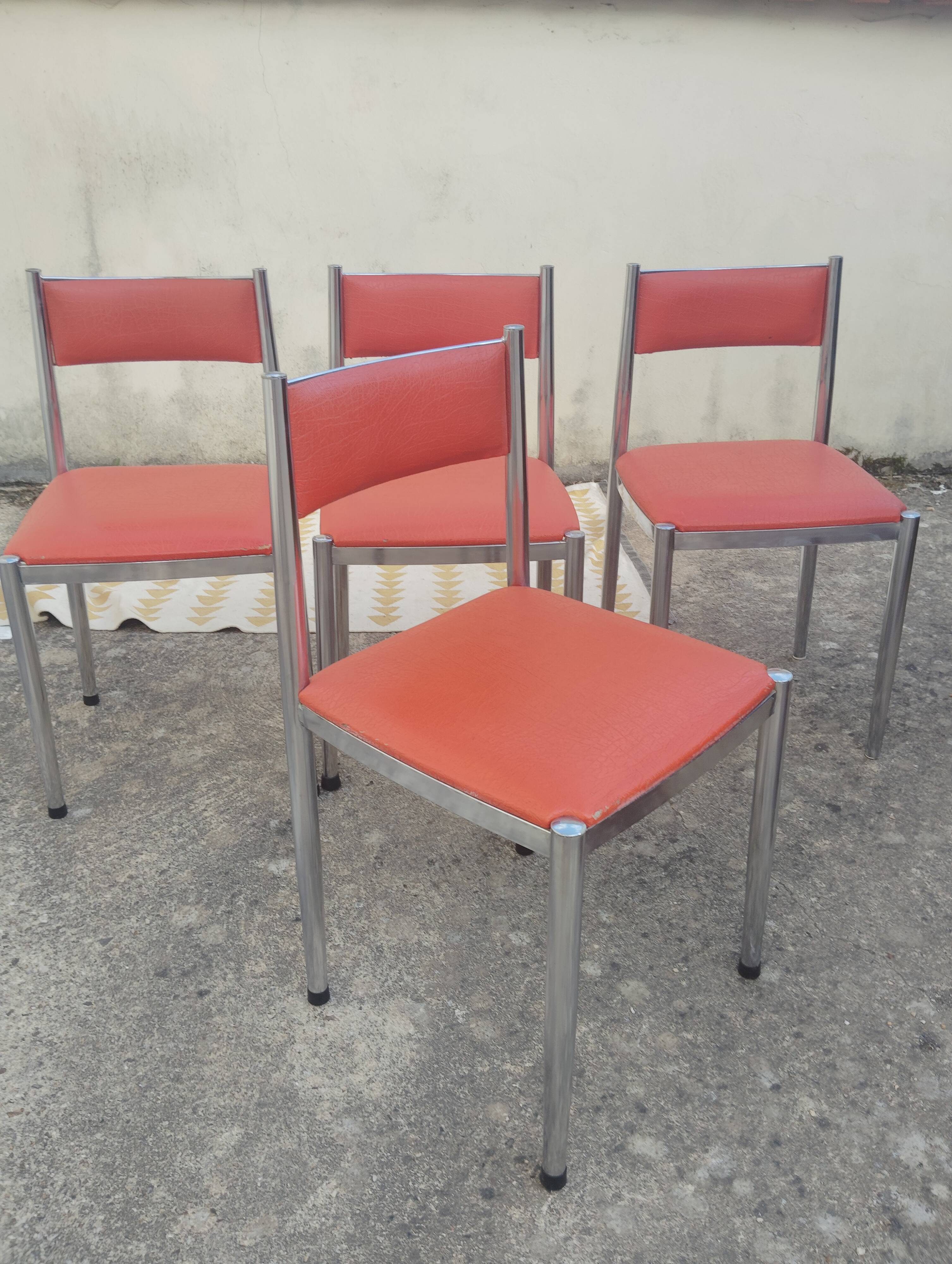 Set of 4 vintage chrome and orange faux leather chairs.
