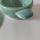 Earthenware bowl and saucer in glazed water green ceramic.