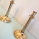 Pair of empire style brass candlesticks