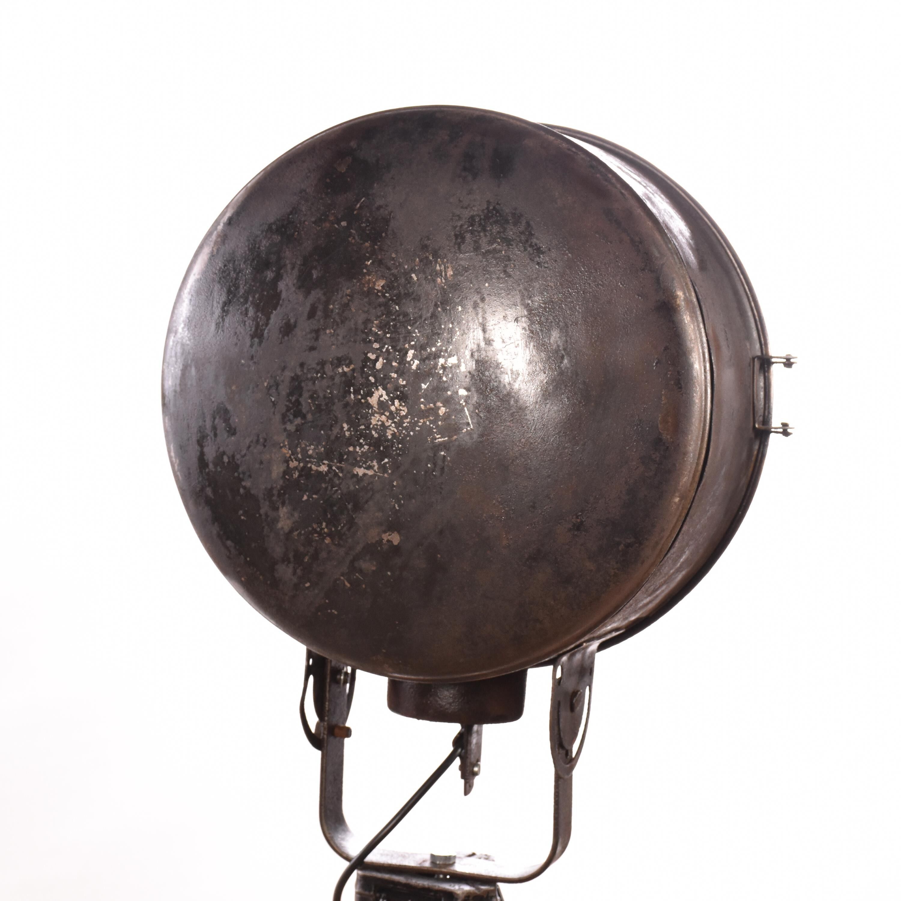 Old industrial spot on wooden tripod floor lamp