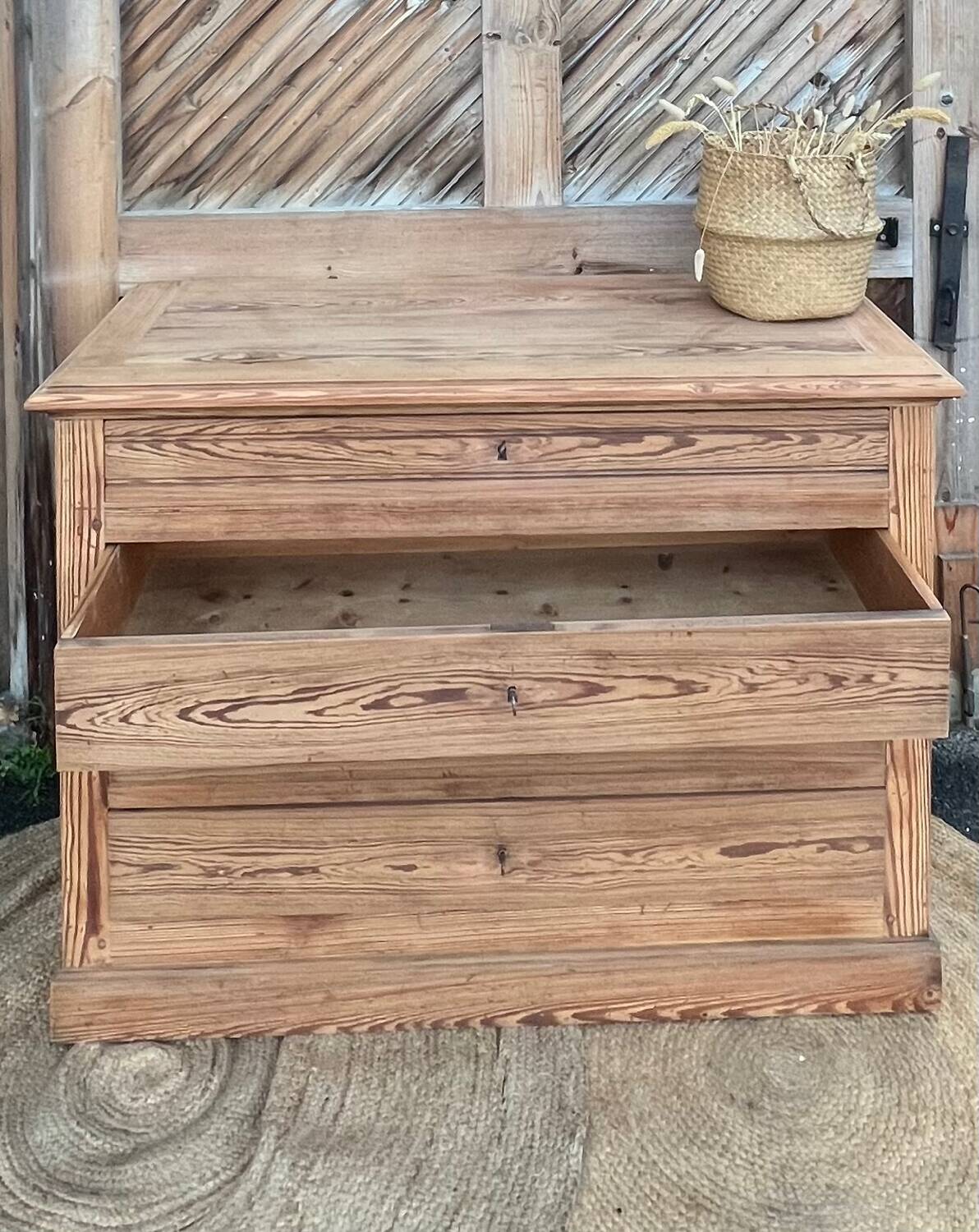 Large antique chest of drawers in raw solid wood.