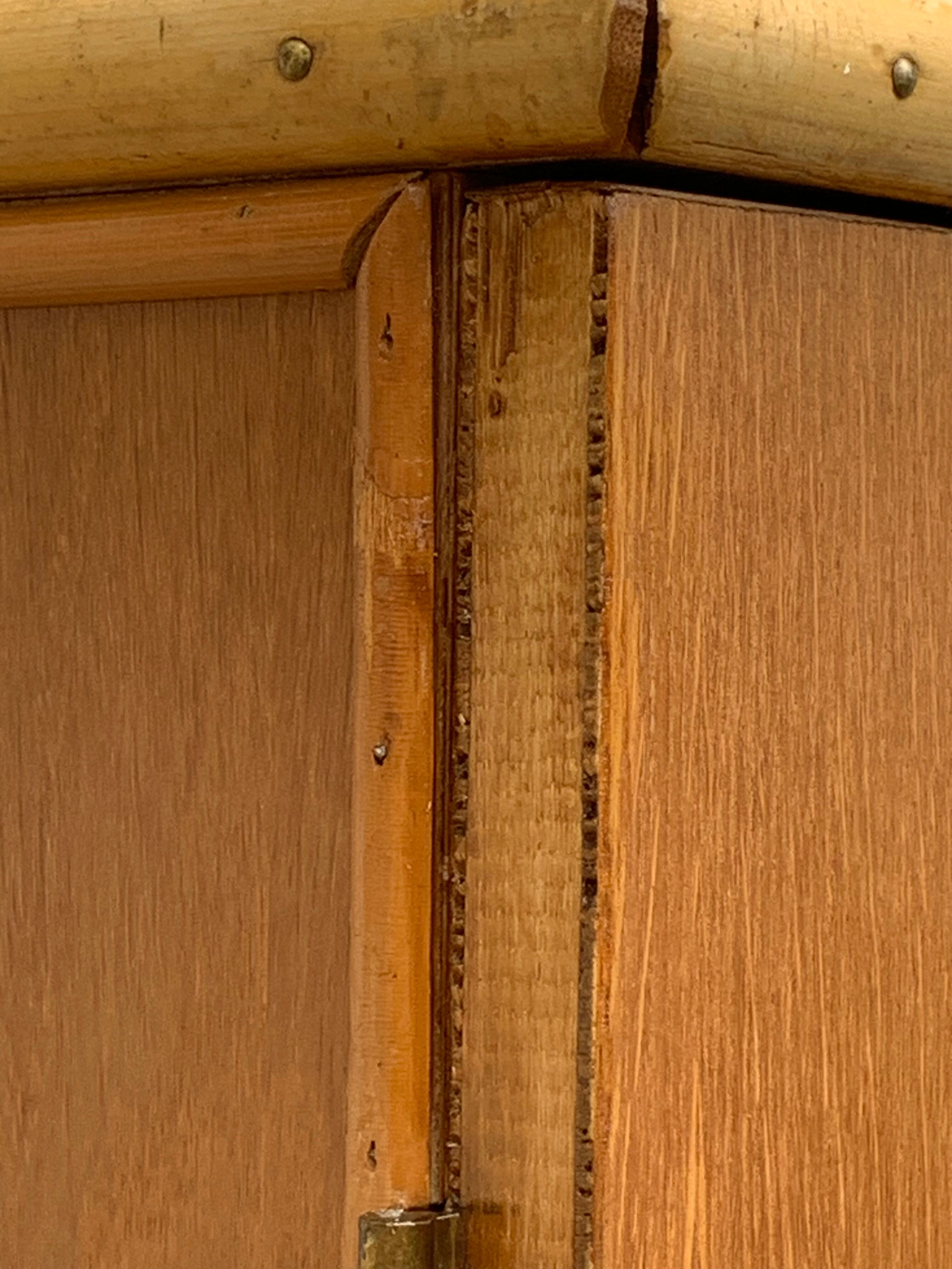 Rattan wardrobe with tapered legs from the 1960s.