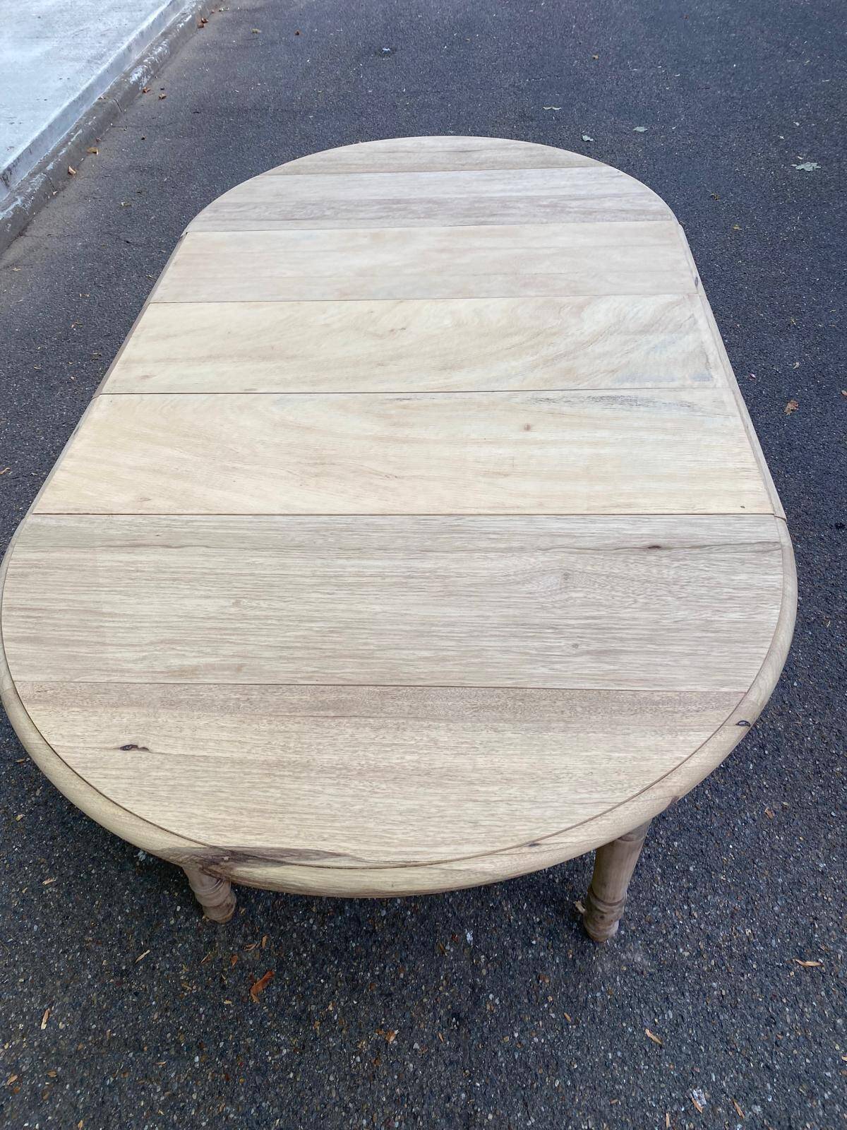 Round extendable dining table with flaps, stripped in raw oak, with 3 extensions.