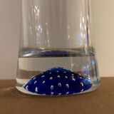 Glass roller vase with blue bubble background