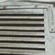 Old wooden shutter with perforations.