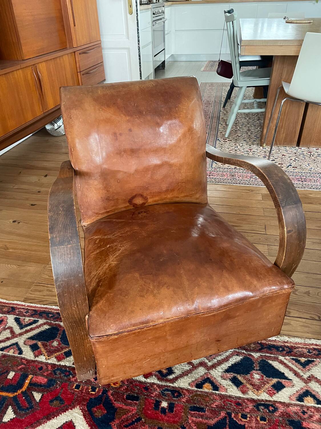 Vintage leather club chair with wooden armrests