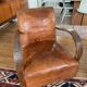 Vintage leather club chair with wooden armrests