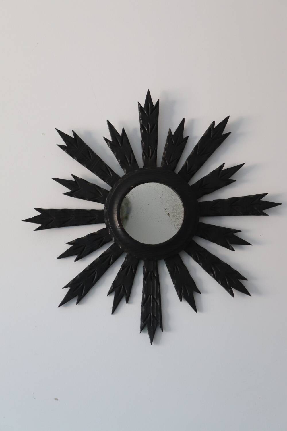 Antique black wooden sun mirror