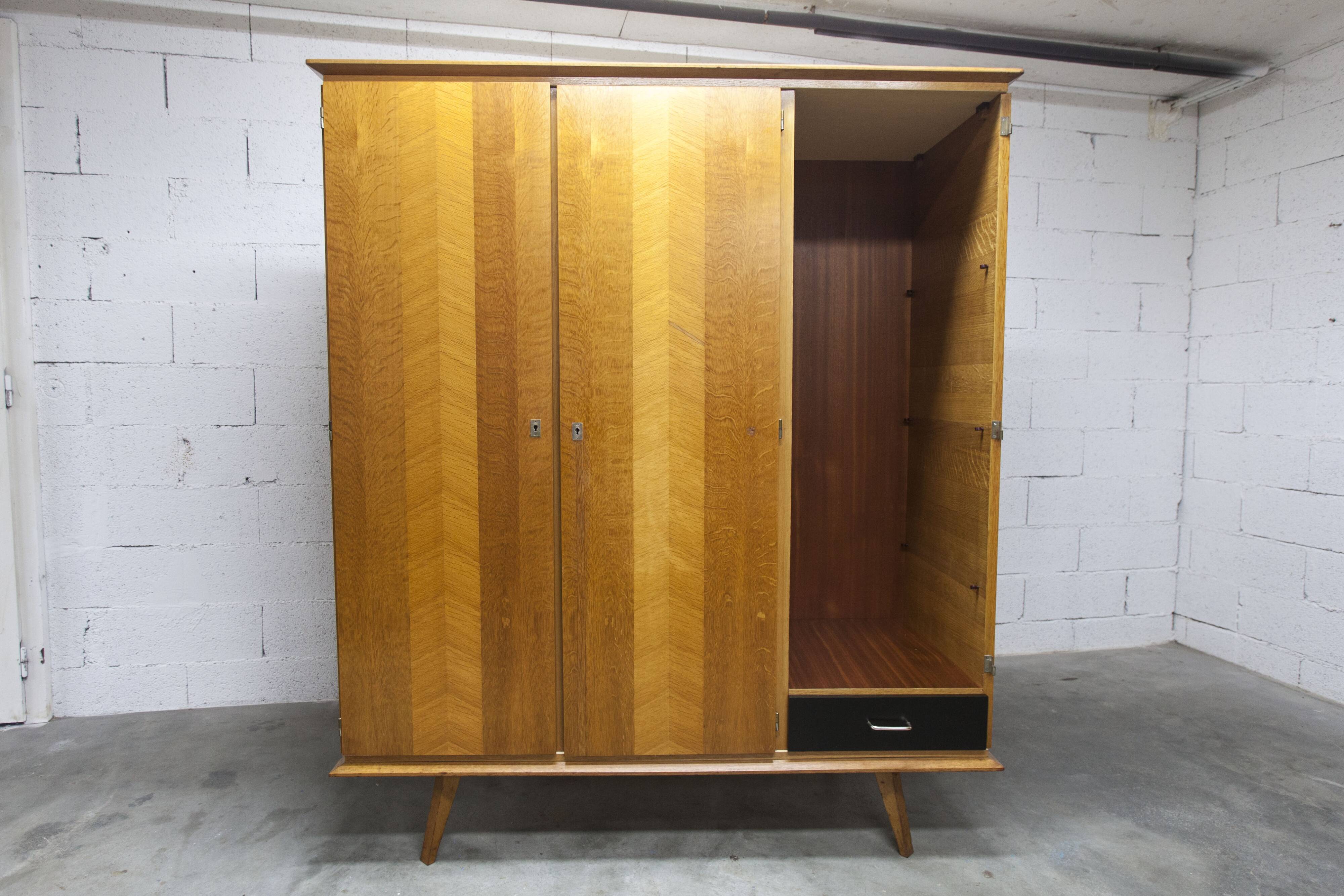 French wardrobe with tapered legs, 3 doors, 1 mirror (27*130), and 1 drawer.