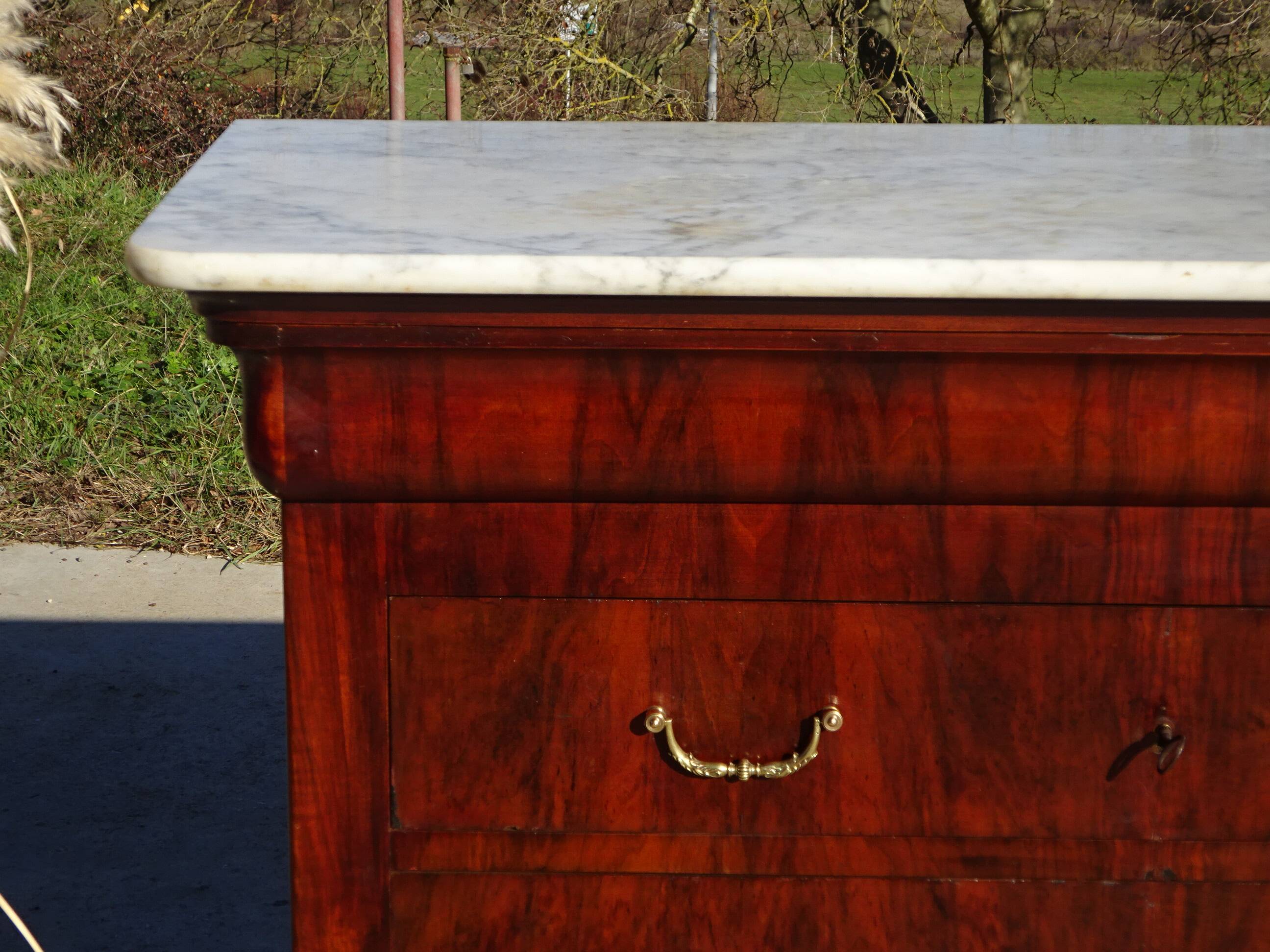 Antique mahogany chest of drawers with white marble.