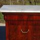 Antique mahogany chest of drawers with white marble.