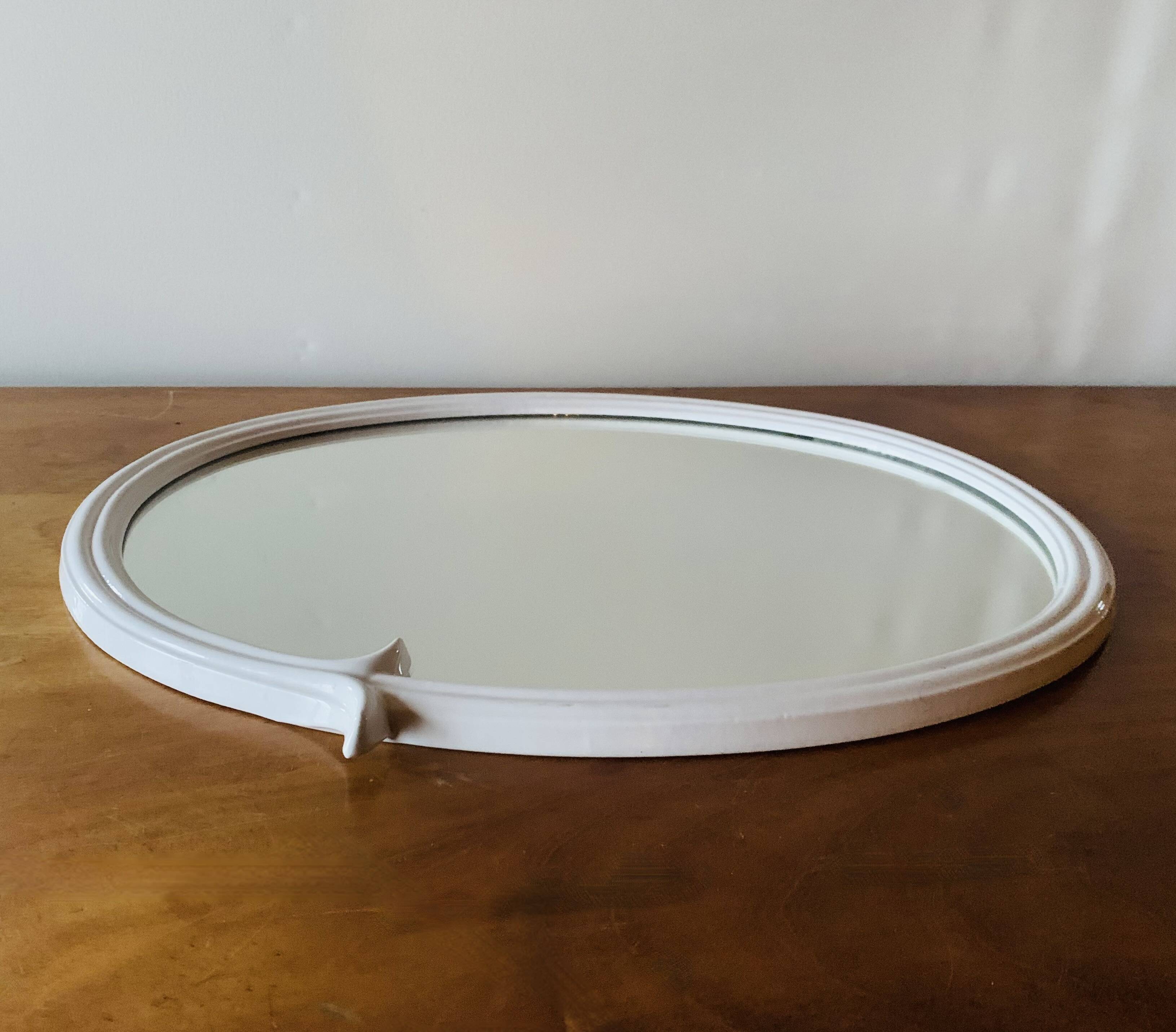 Oval mirror in vintage enameled white cast iron