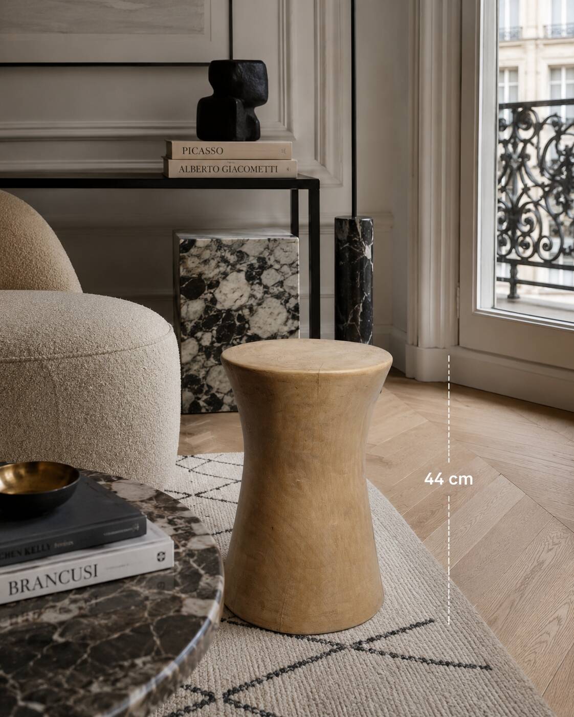 Brutalist monoxyle stool in solid mango wood, hourglass shape.