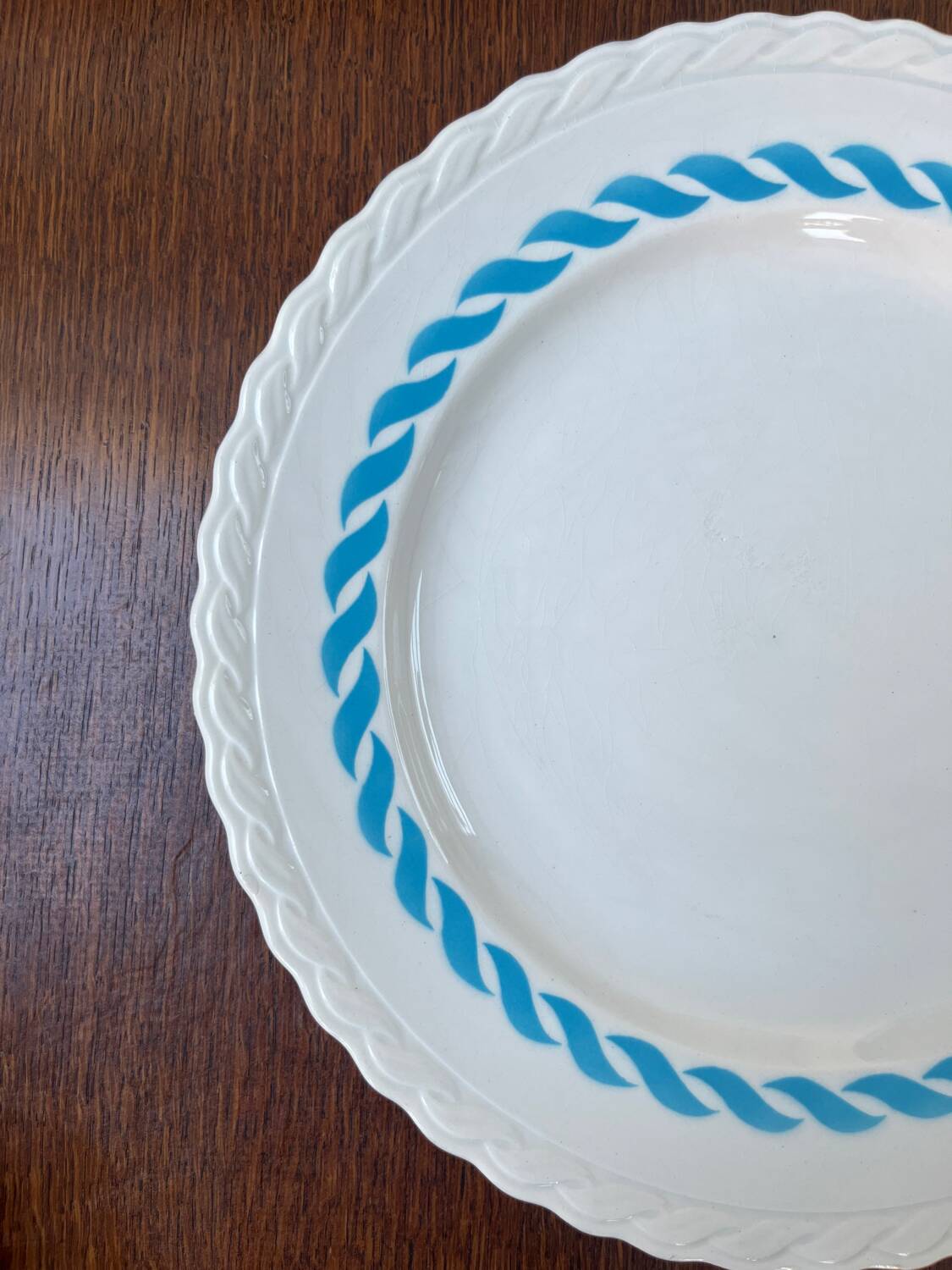 Round vintage plate in earthenware – twisted blue decoration