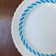 Round vintage plate in earthenware – twisted blue decoration
