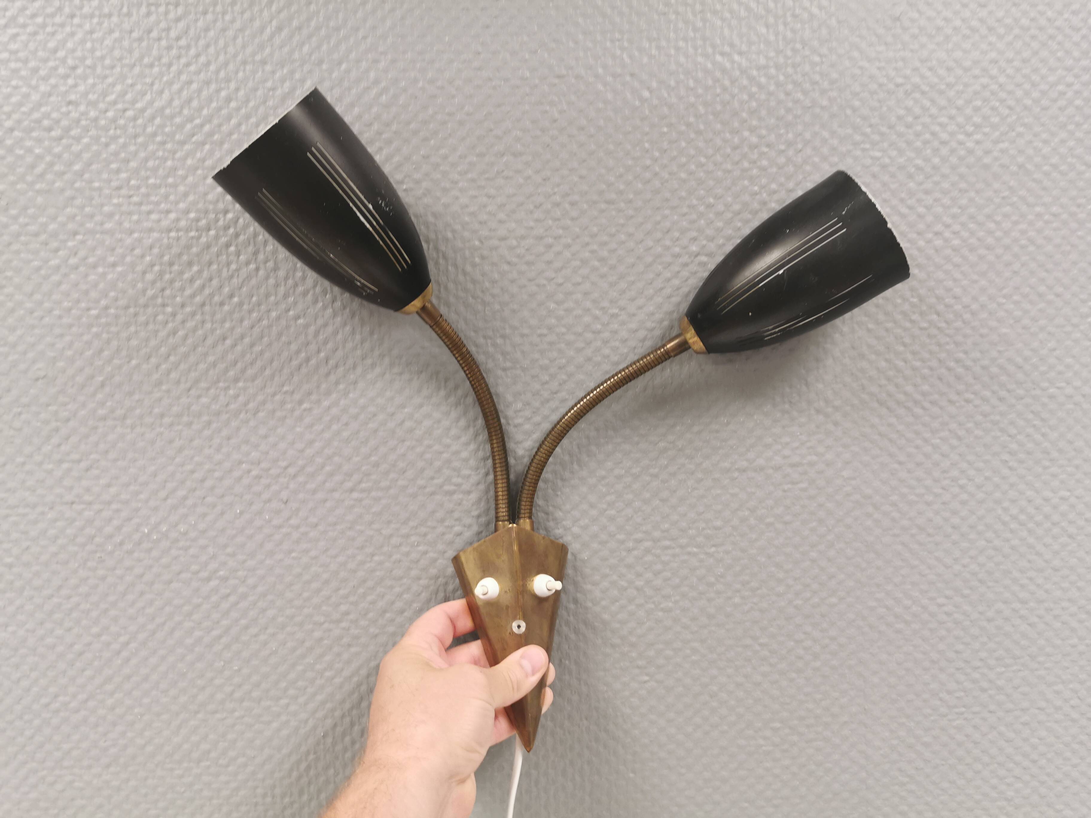 Older wall lamp with black metal shades and brass bend ‘arms’