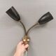 Older wall lamp with black metal shades and brass bend ‘arms’