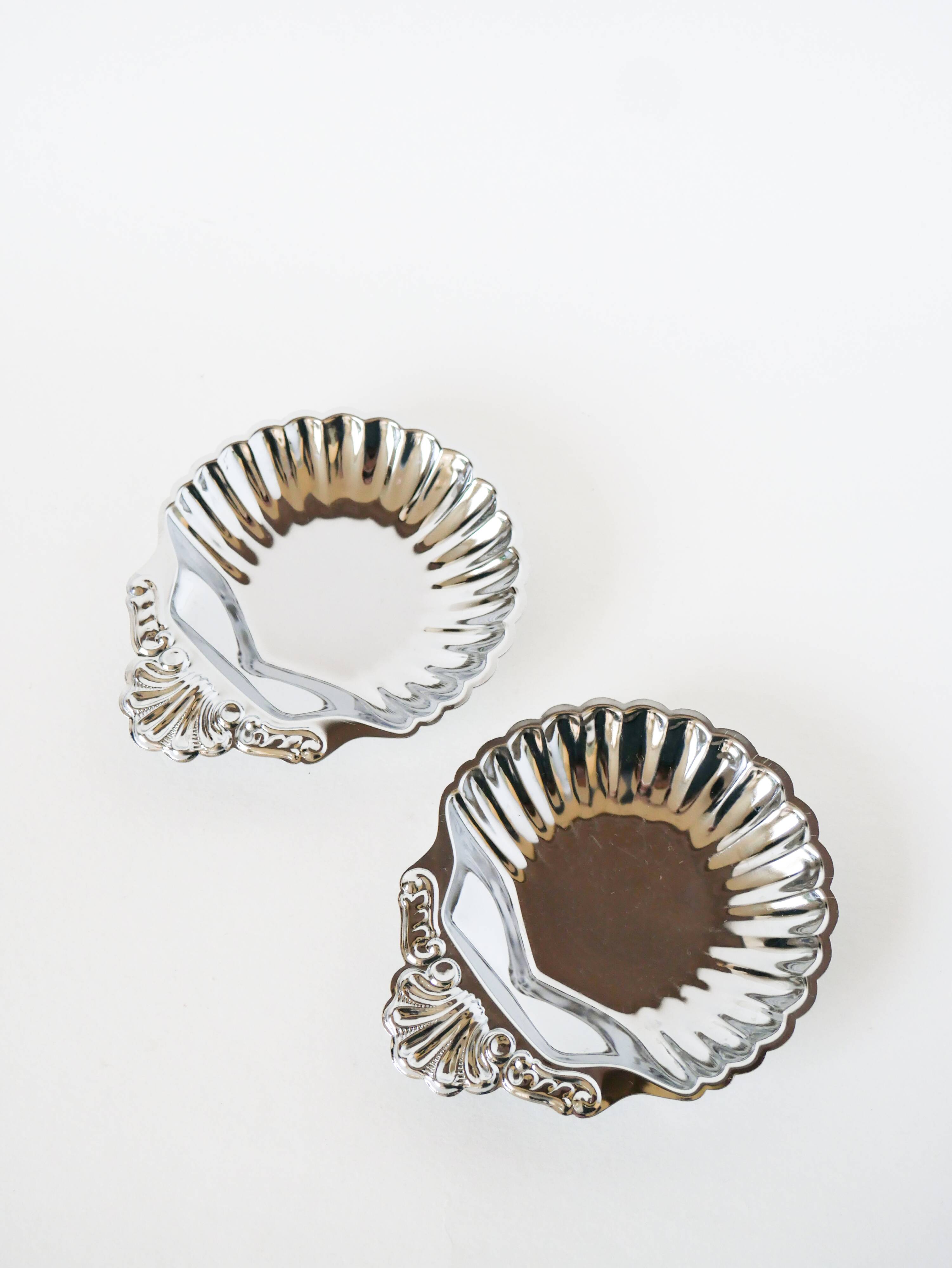 Pair of worked stainless steel shell trinket trays, 1970