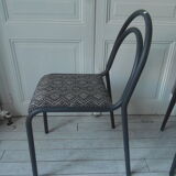Indus chair with tubular structure in slate gray metal waxed finish, upholstered seat.