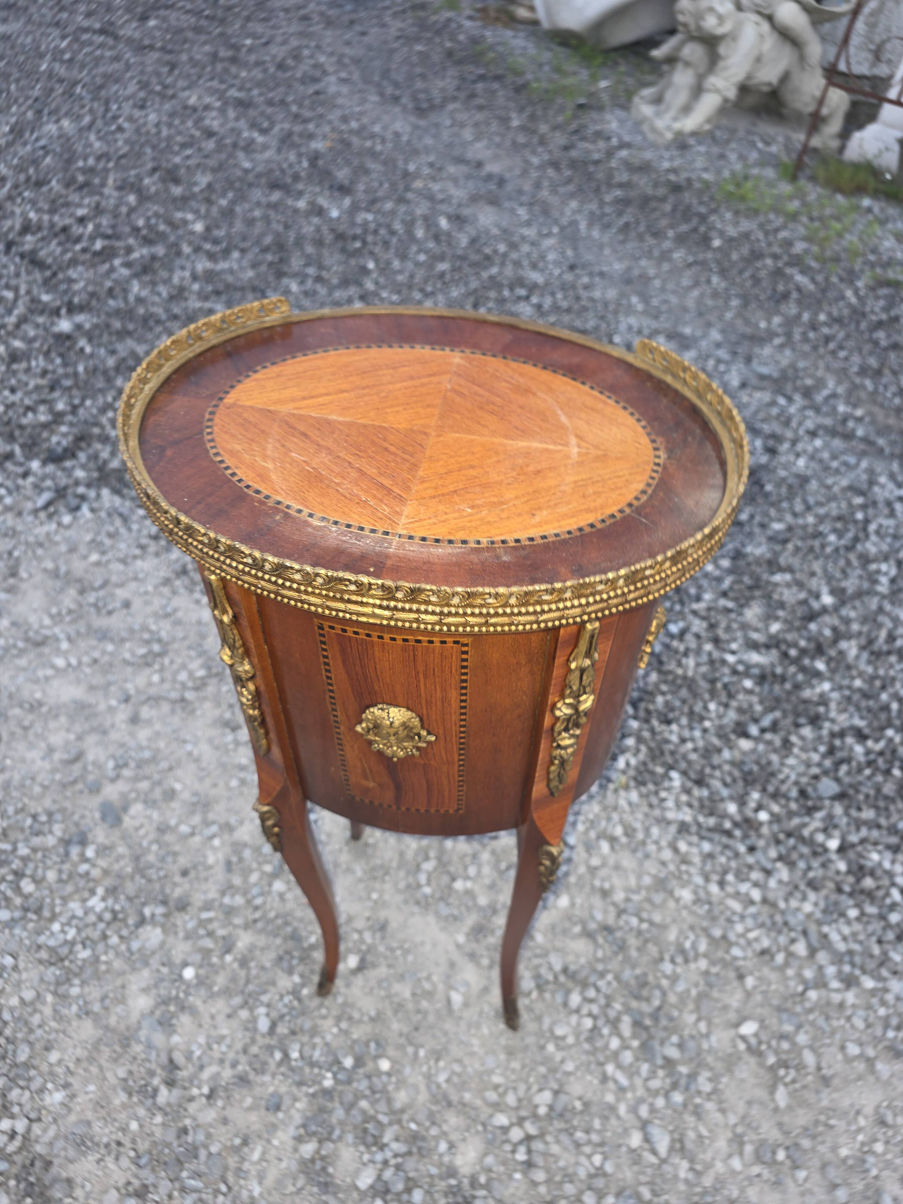 Oval bedside table in Louis XV style with marquetry.