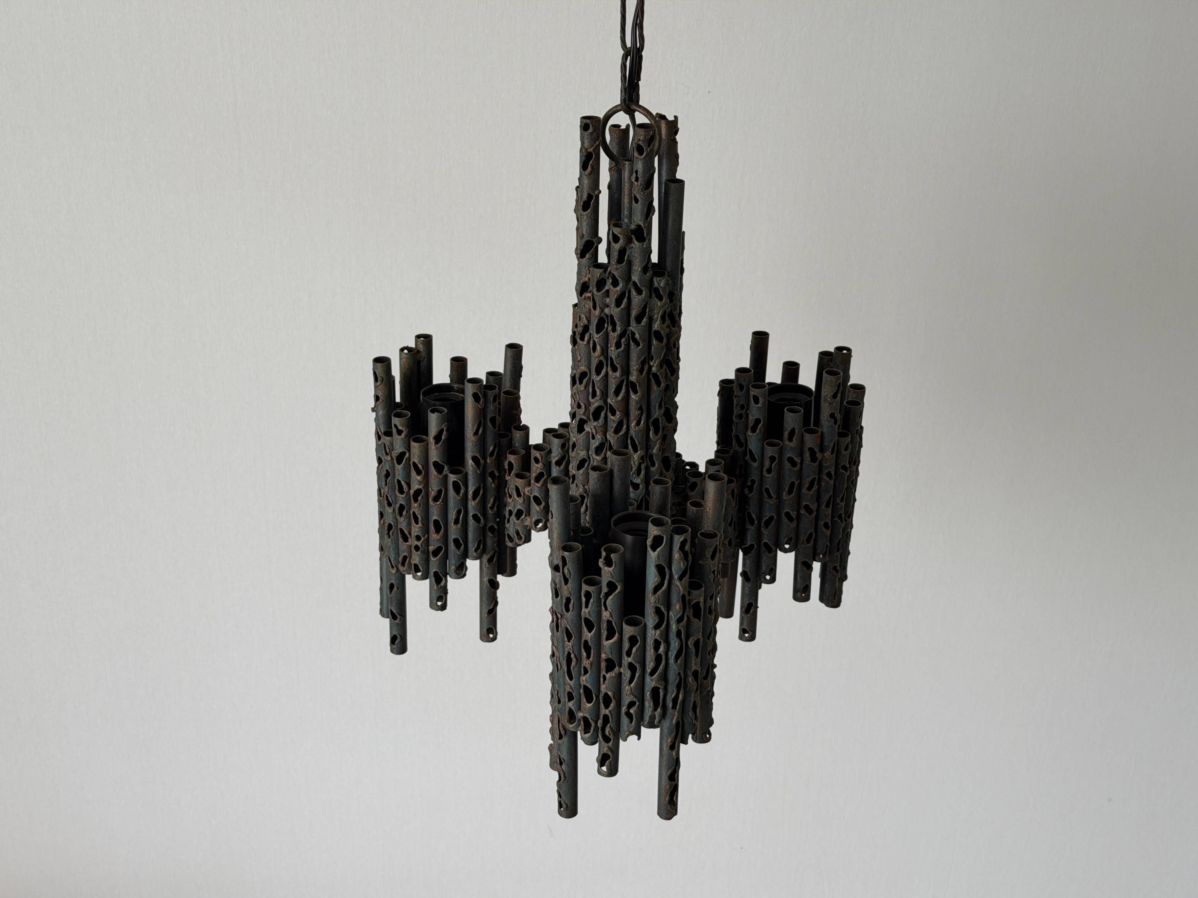Three-armed suspended lamp in wrought iron, brutalist design, 1960s, Italy.