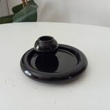 Vintage black ceramic candle holder on a bowl