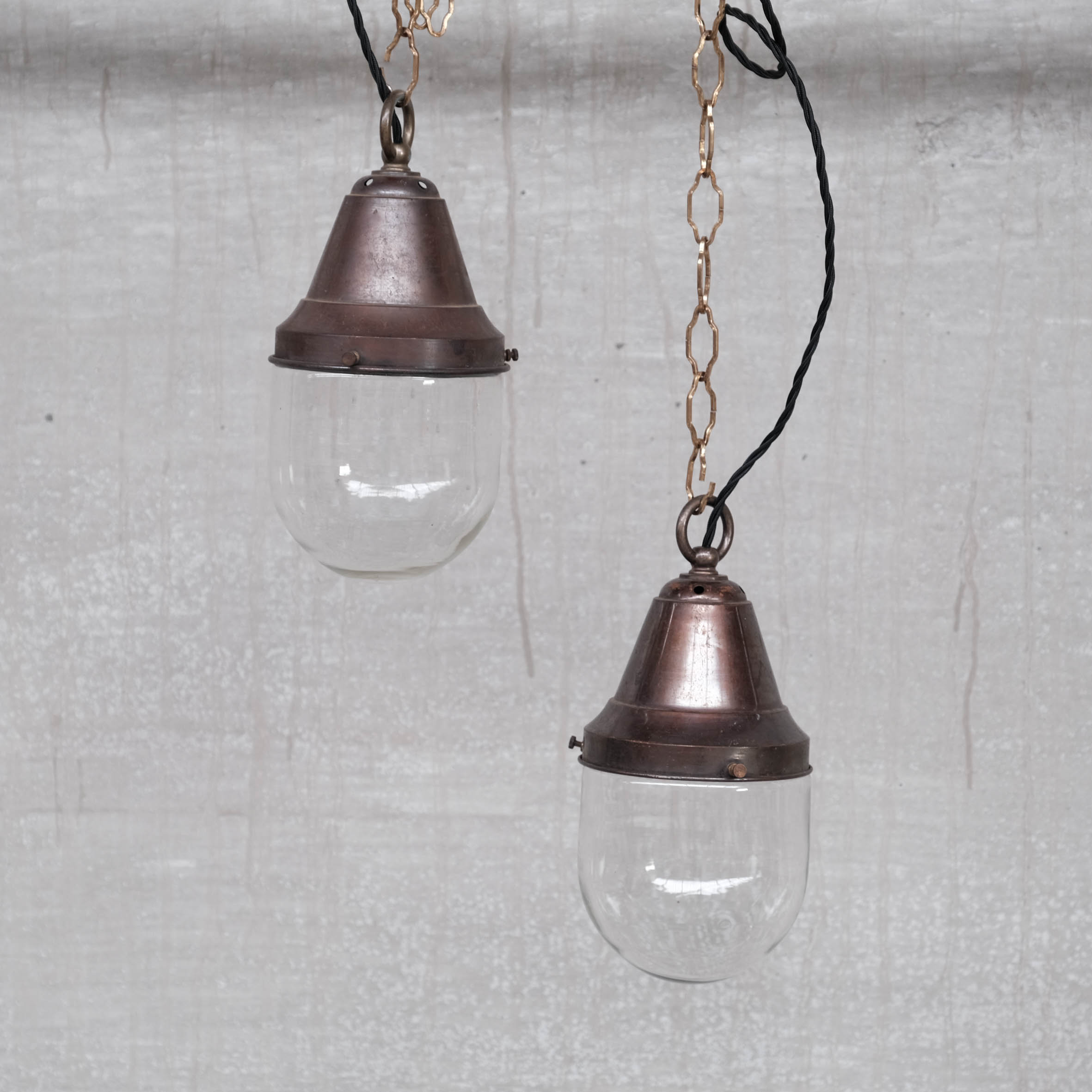 Pair of brass and clear glass industrial pendants