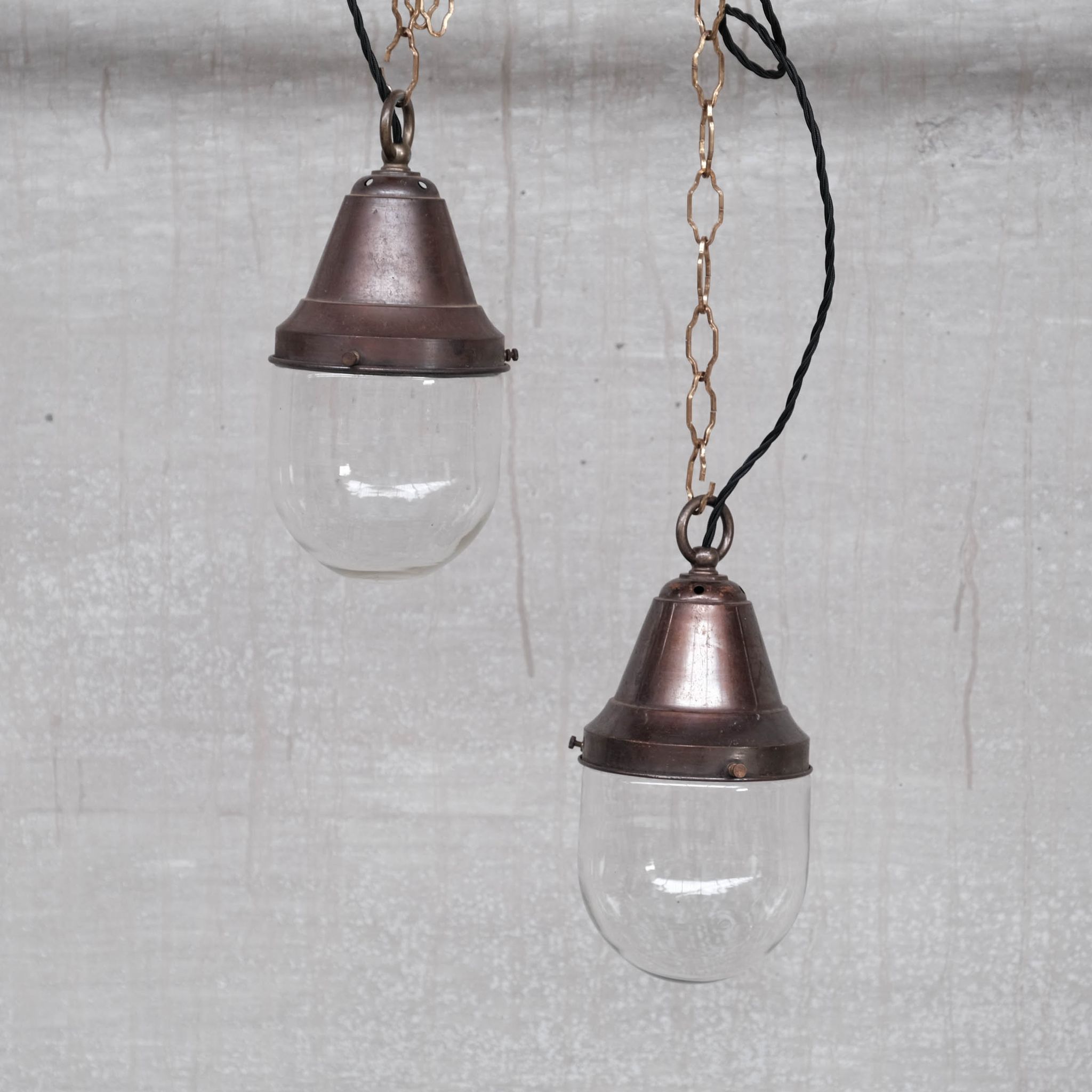 Pair of brass and clear glass industrial pendants