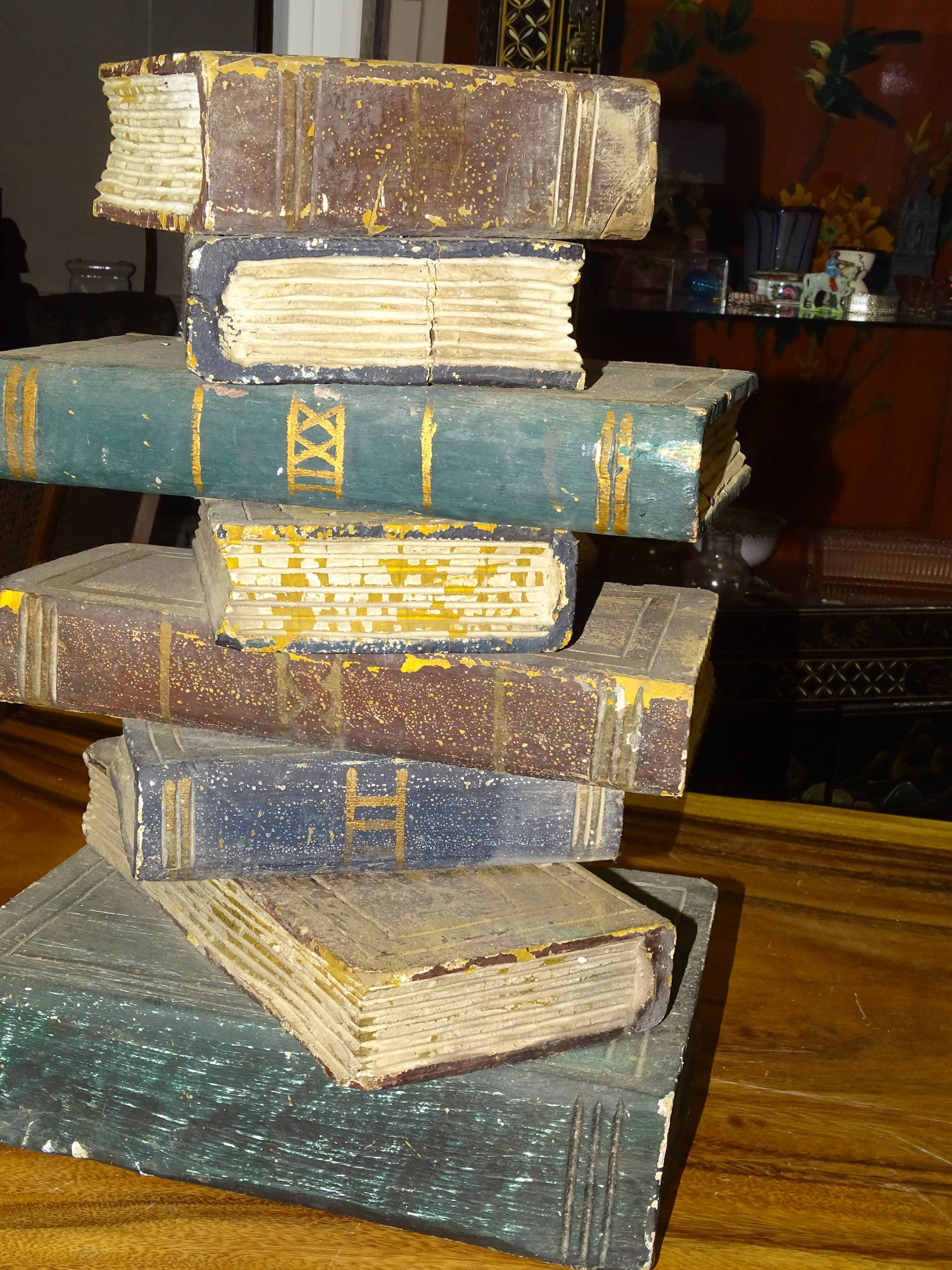 side table, end of sofa stack of wooden books, old, beautiful patina