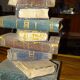 side table, end of sofa stack of wooden books, old, beautiful patina