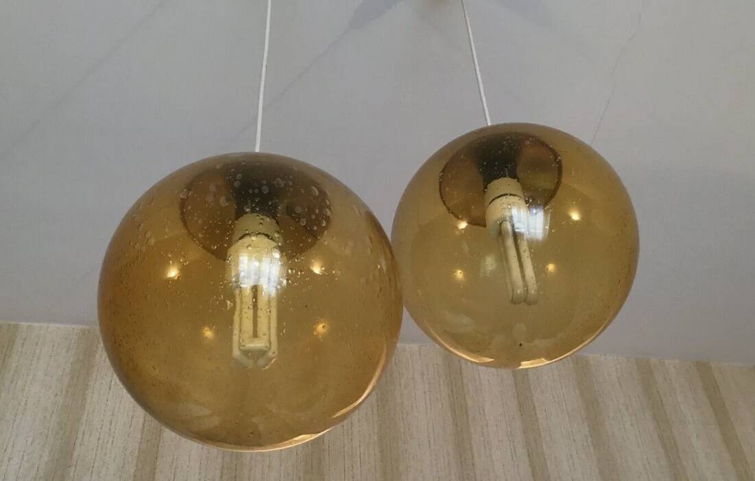 Pair of vintage smoked glass ball pendant lights from Biot glassworks