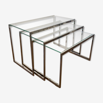 Modernist work, suite of three trundle tables in chromed metal and glass