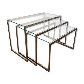 Modernist work, suite of three trundle tables in chromed metal and glass