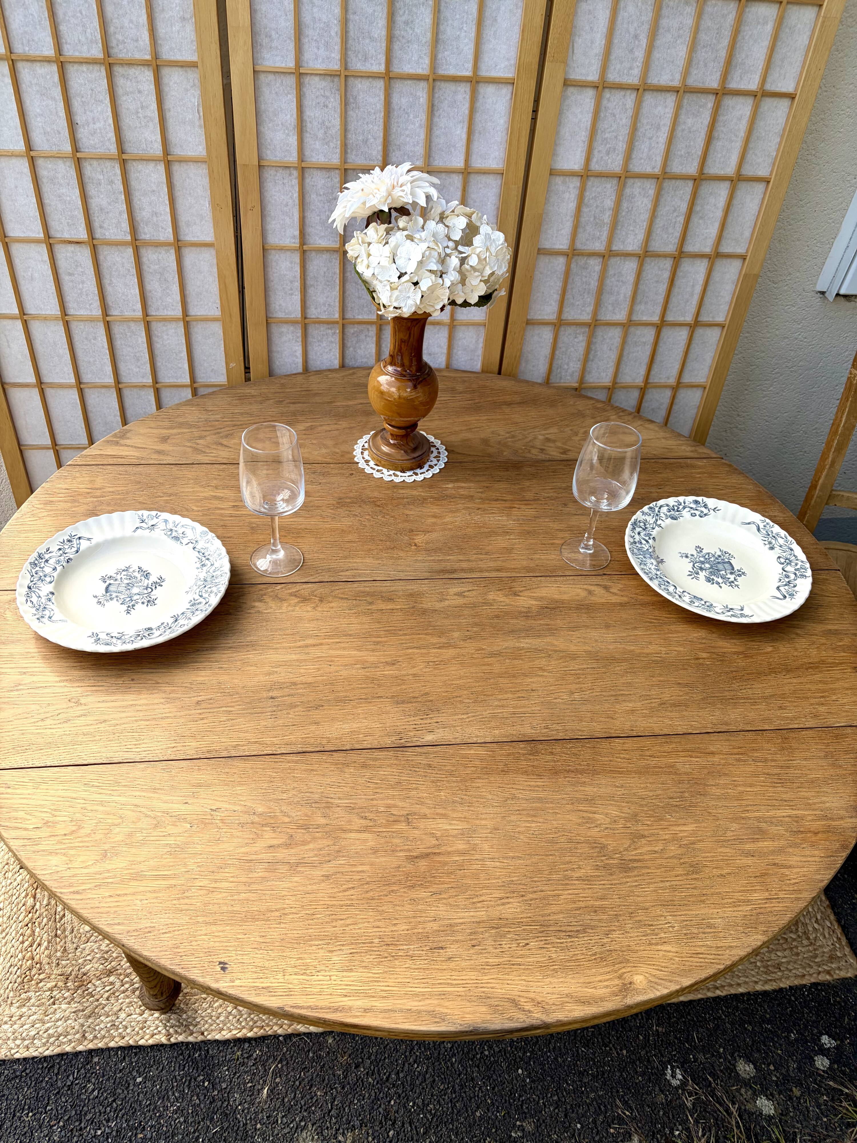 Round oak table with a drop leaf.